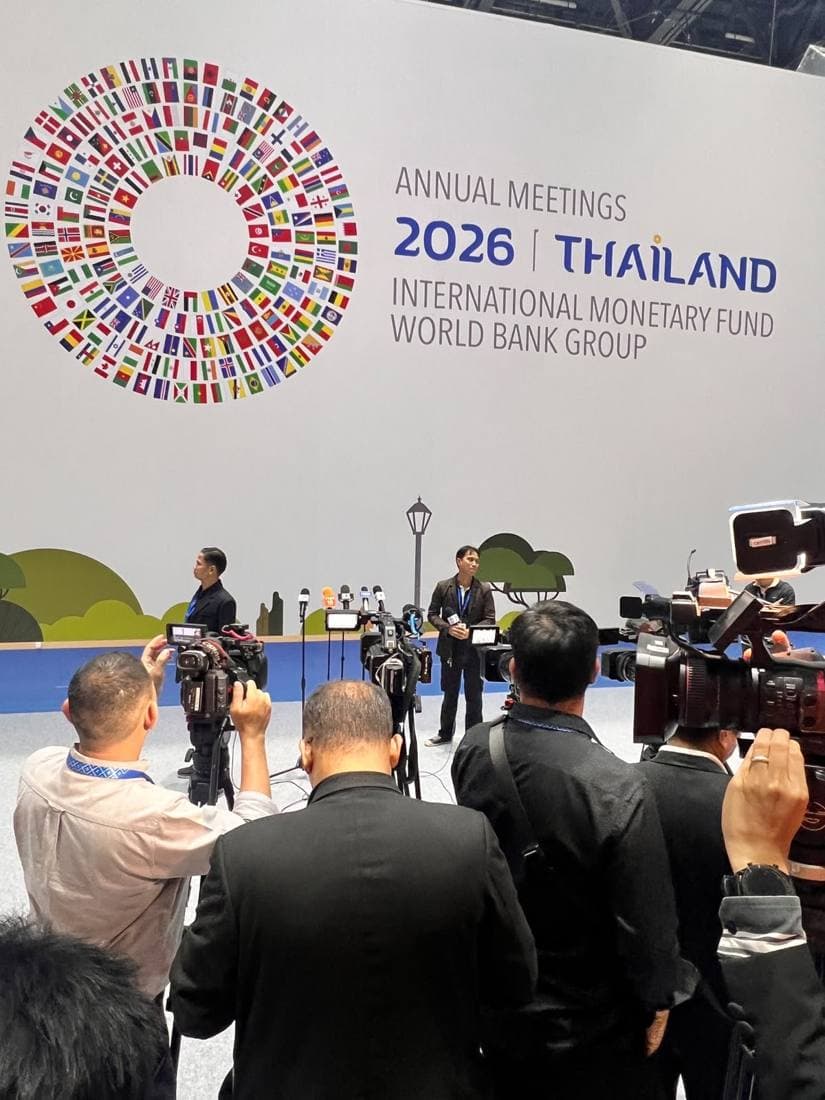 Camera crews setting up in front of the Annual Meetings 2026 Thailand backdrop